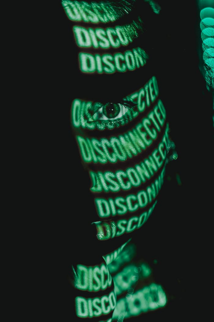 Close-up portrait featuring green digital text projection on face creating a futuristic aesthetic.